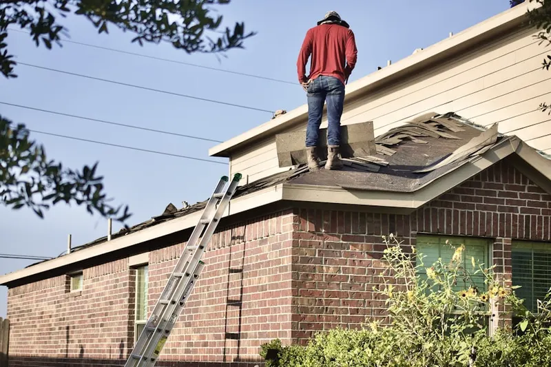 Professional roofer working on a residential roof in Shady Lawn Manor